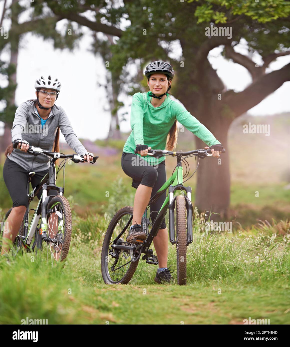 Biking buddies. Two young cyclists enjoying their ride along a trail