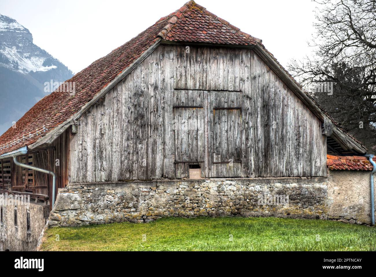 The facade of an old weathered wooden barn Stock Photo