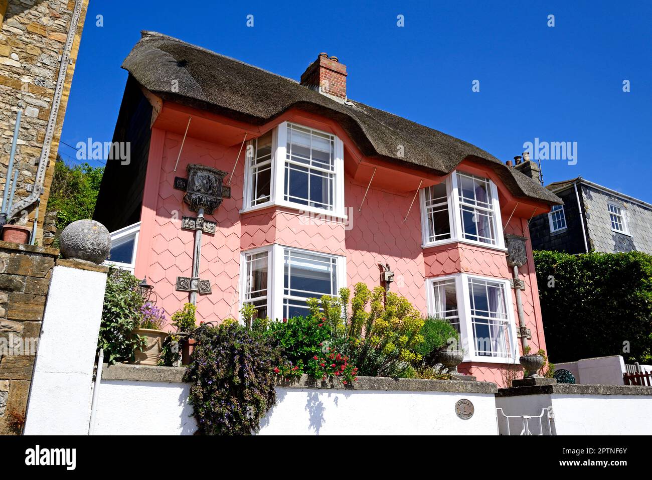 Front view of an attractive thatched pink tiled house called Library