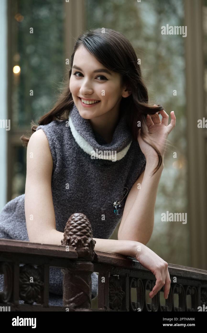 Happy girl posing in knitted dress with collar and without sleeves