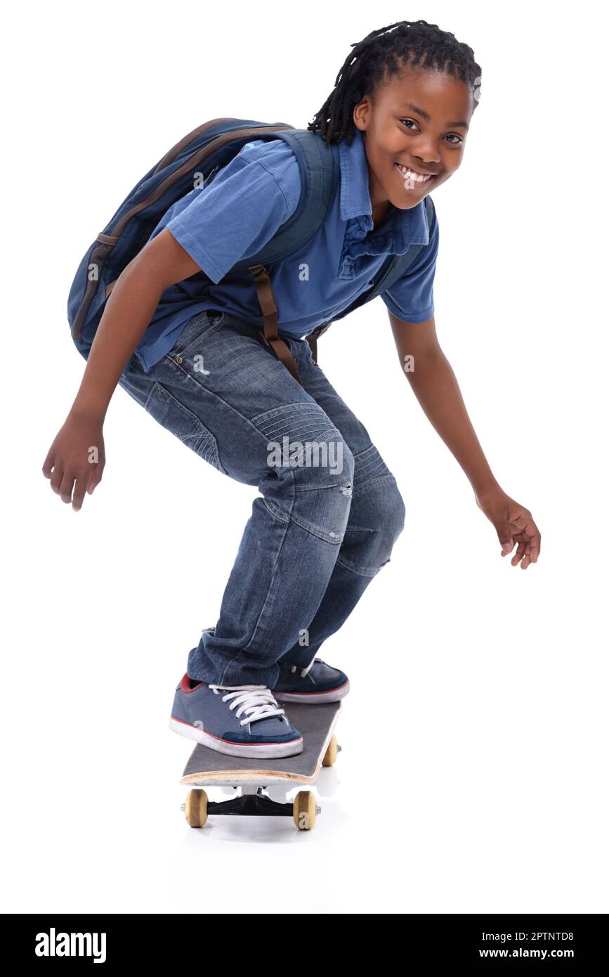 Showing off his mad skills. A young African-American boy doing a trick on his skateboard Stock Photo