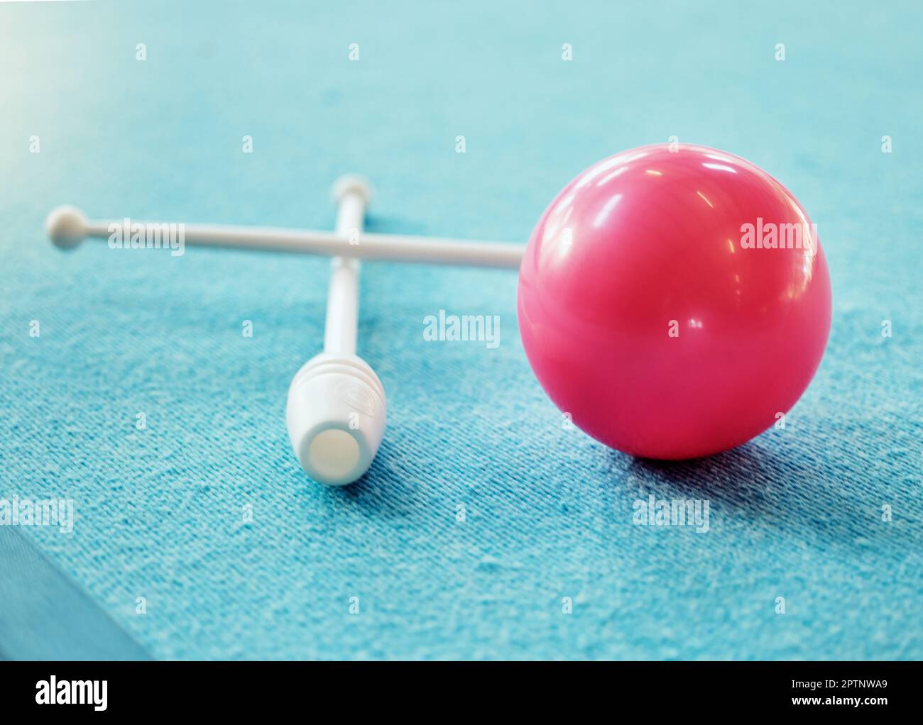 A red ball on the floor on a blue carpet with gymnastics club. Gym