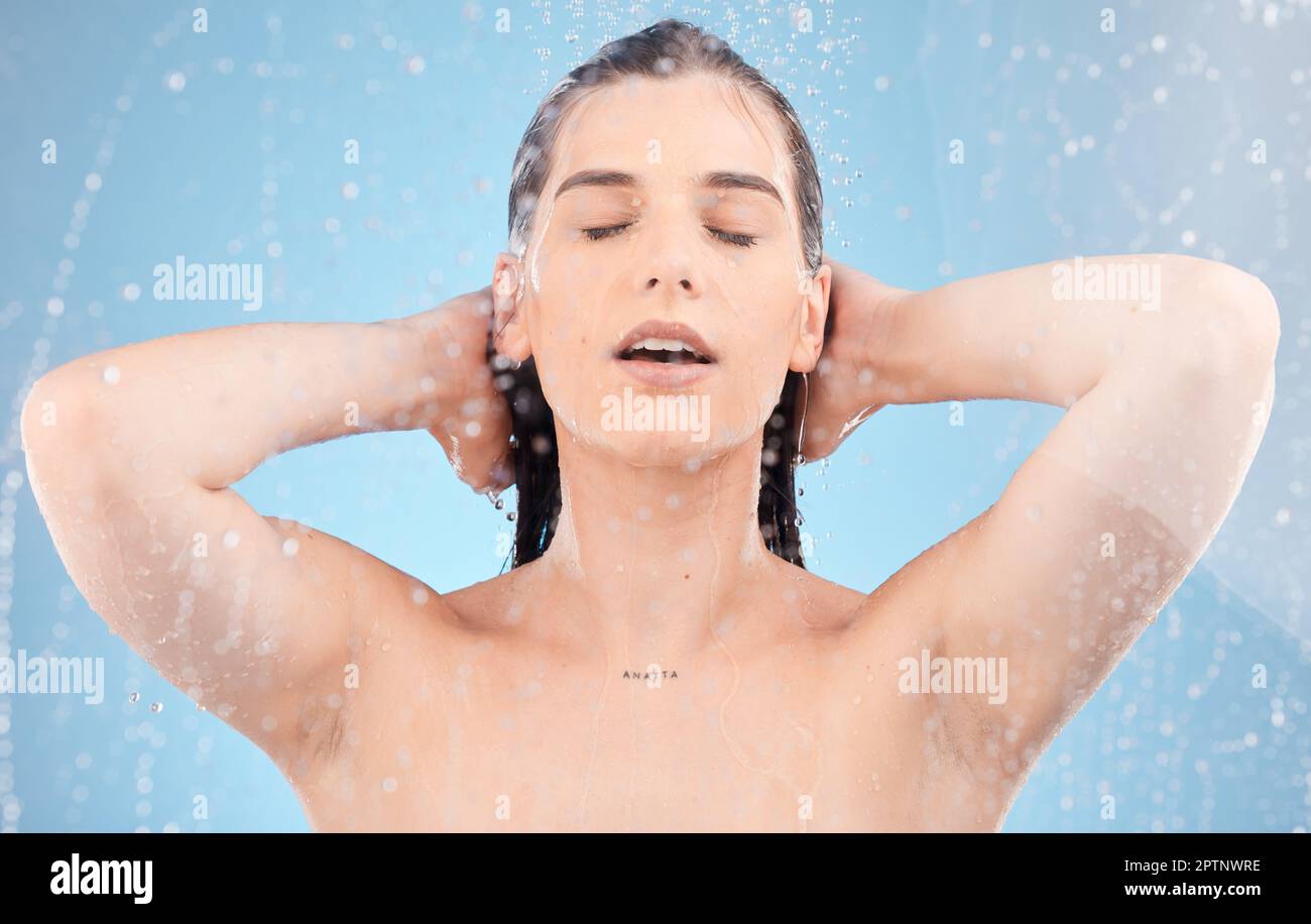 Water, woman and body shower on blue background for healthy skincare