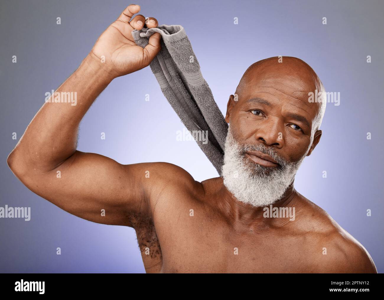 Shower, cleaning and senior black man grooming, hygiene and body wellness from a spa sauna on a purple background in studio. Retirement glow, self car Stock Photo
