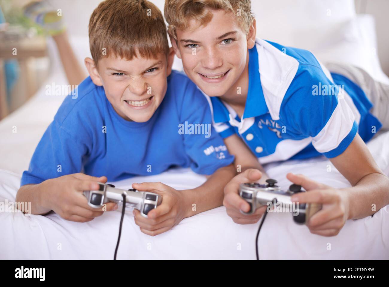 This game just got interesting. Two brothers playing video games Stock  Photo - Alamy