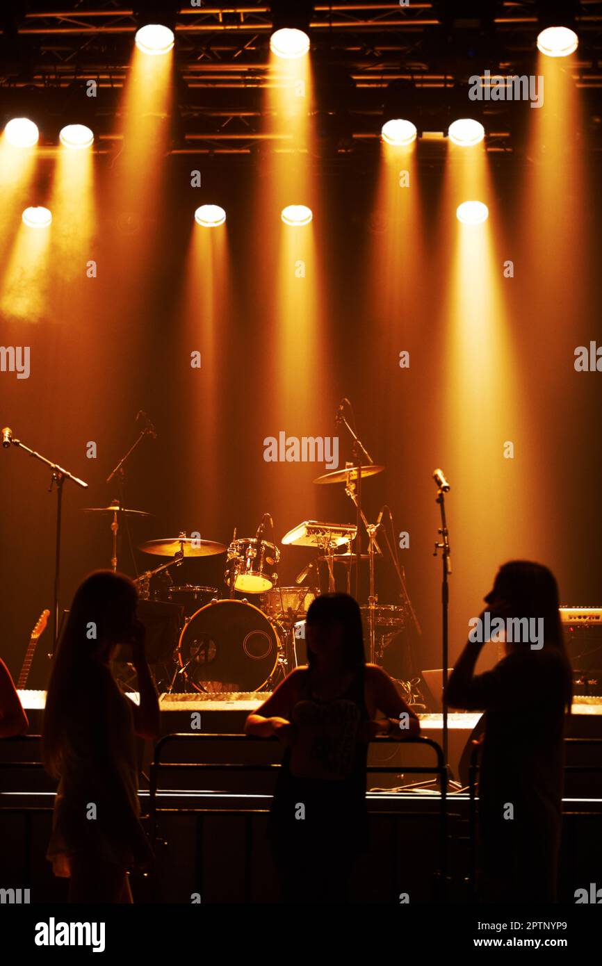 Silhouette of a band playing onstage. This concert was created for the
