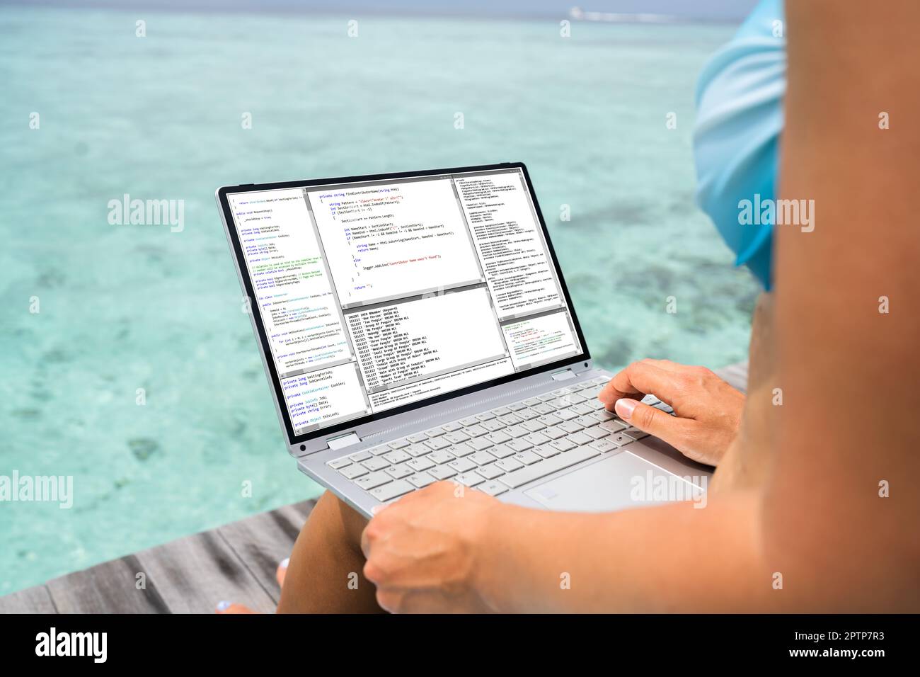 Computer Programmer Using Development Software On Laptop On Vacation
