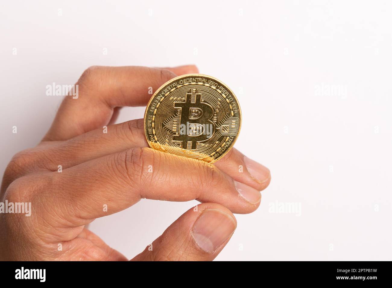 Invest in the future with Bitcoin. Holding a Bitcoin in hand symbolizes the digital currency's growing popularity and potential for massive gains. Don Stock Photo
