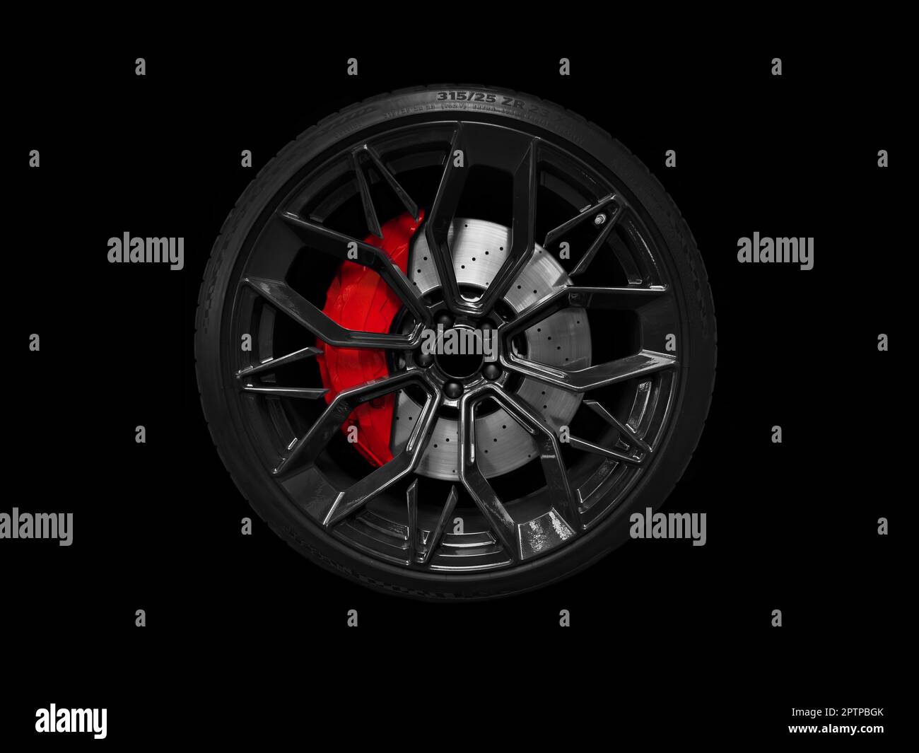 Car alloy wheel and tyre isolated on black background. New alloy wheel