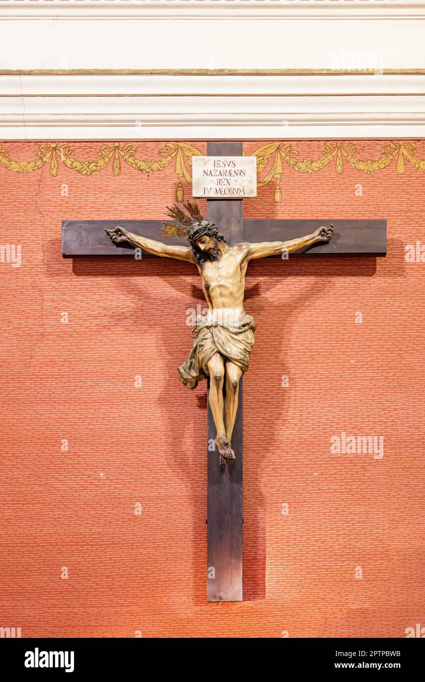 Jesus Christ on the cross with a sign in Latin with the text 'IESUS NAZARENUS REX IUDAEORUM' which means Jesus of Nazareth, King of the Jews Stock Photo