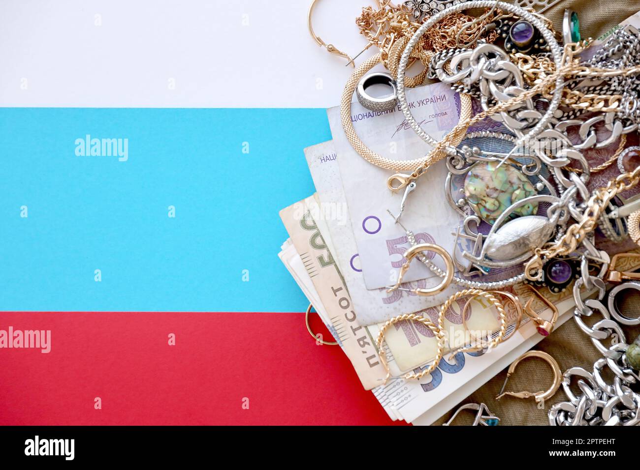 Bunch of stolen jewelry and money on military uniform cloth fabric and