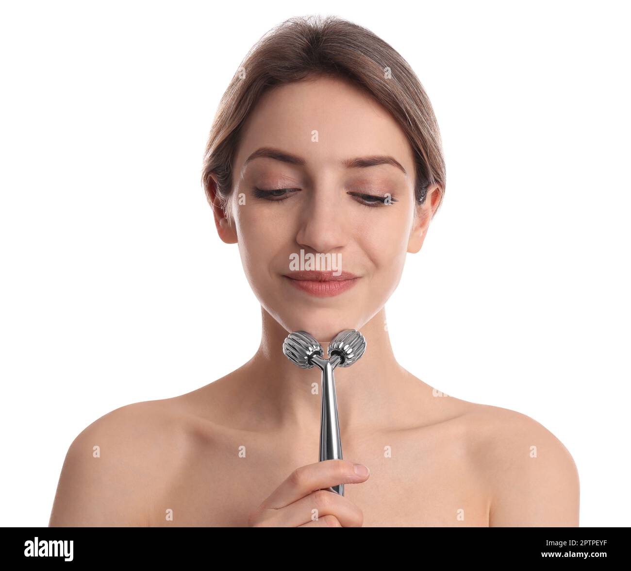Young woman using metal face roller on white background Stock Photo - Alamy