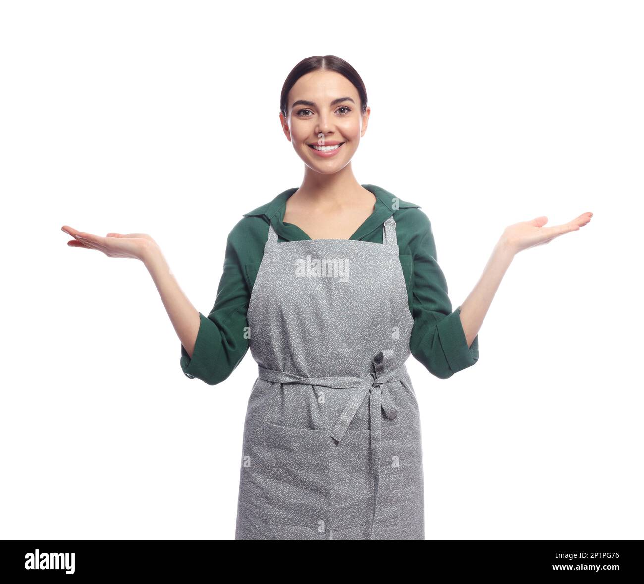 Young woman in grey apron on white background Stock Photo - Alamy