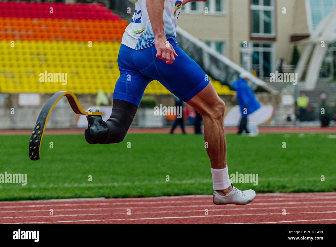 close-up male para athlete on limb deficiency running track stadium, summer para athletics championships Stock Photo