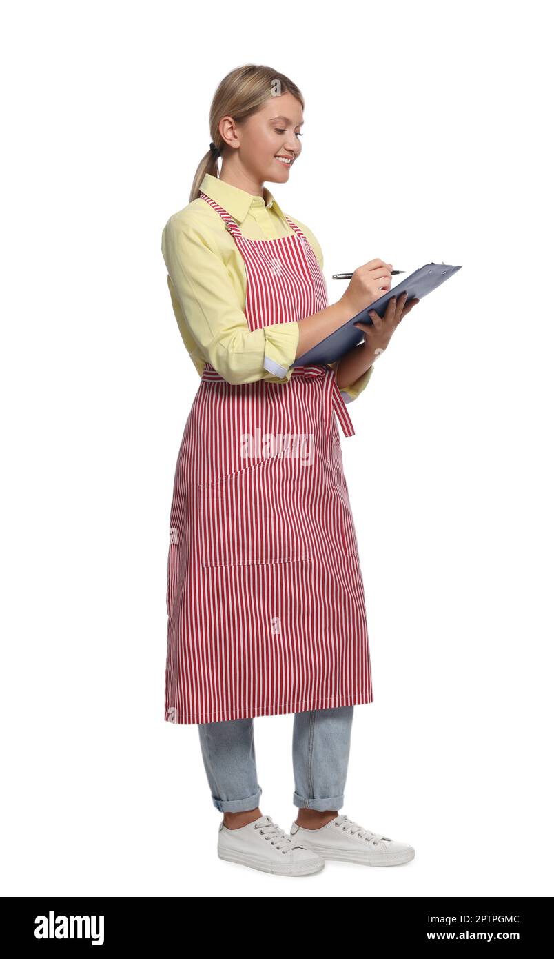 Beautiful young woman in clean striped apron with clipboard on white ...