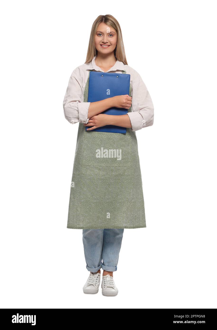Beautiful young woman in clean apron with clipboard on white background ...