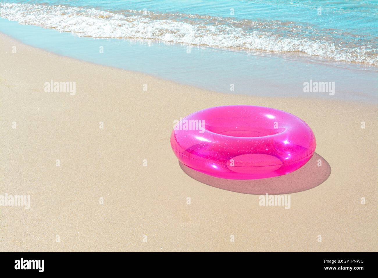 Bright inflatable ring on sandy beach near sea. Space for text Stock ...