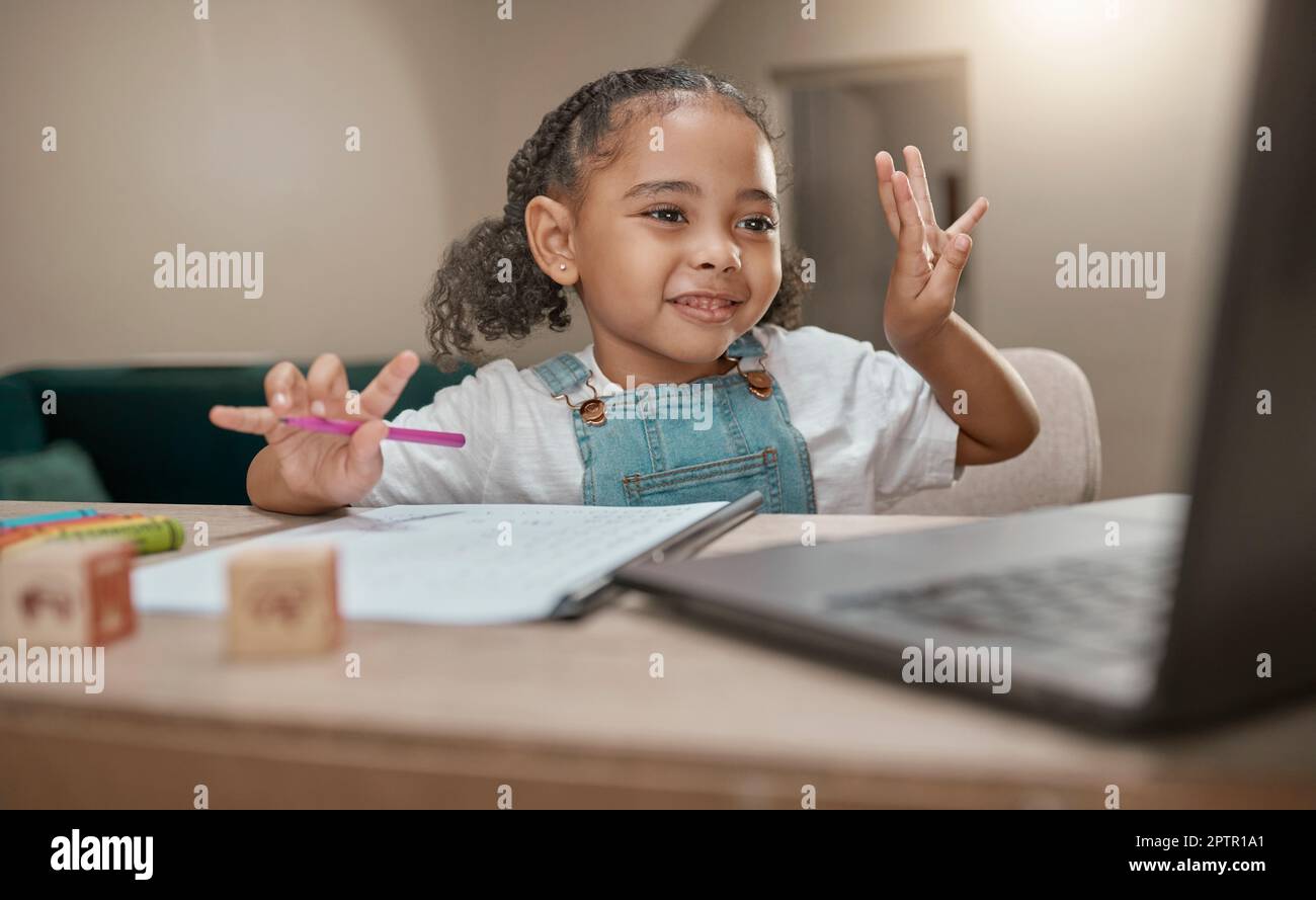 Girl, learning and elearning on laptop, math and education in homeschool, writing and online class at desk in home. Child, happy smile and count for d Stock Photo