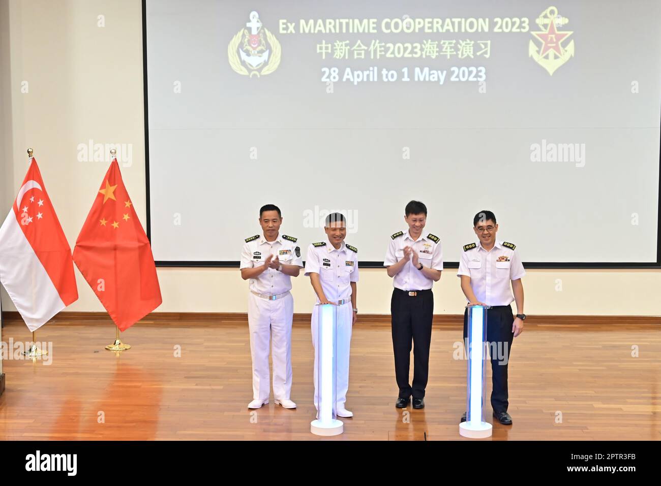 April 28, 2023, Changi, Changi, Singapore: In this photo provided by Singapore's Ministry of Defence, at RSS Singapura ''“ Changi Naval Base, Chief of Staff of Destroyer Flotilla, Southern Theatre Command, Chinese People's Liberation Army (Navy) (PLA[N]) Senior Captain Mei Leyang (second from left). and Commander First Flotilla, Republic of Singapore Navy (RSN) Colonel (COL) Ng Kok Yeng Daniel (right), officiated the Opening Ceremony for Exercise Maritime Cooperation, which was witnessed by Deputy Chief of Political Work Department of Naval Base, PLA(N), Senior Captain Cheng Guochun (left) and Stock Photo