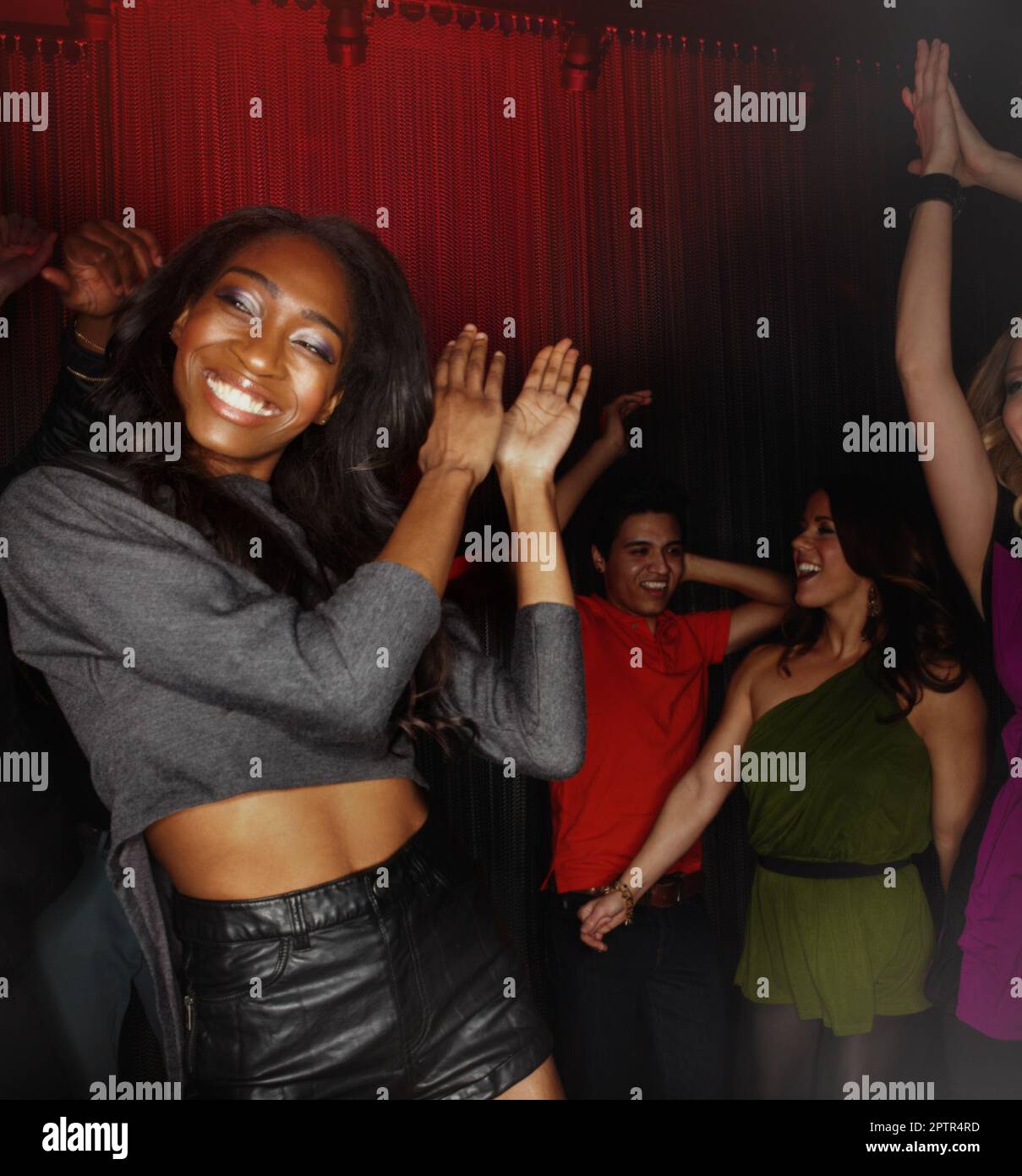 Black woman, dancing and clapping hands in party celebration, event or disco at the night club
