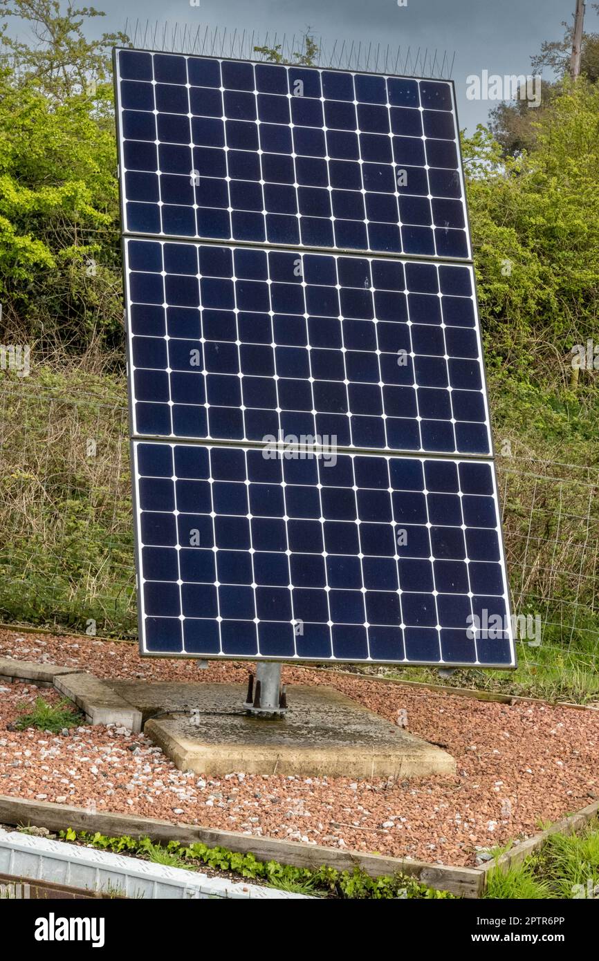 Three solar panels mounted to a stand in Norfolk countryside Stock