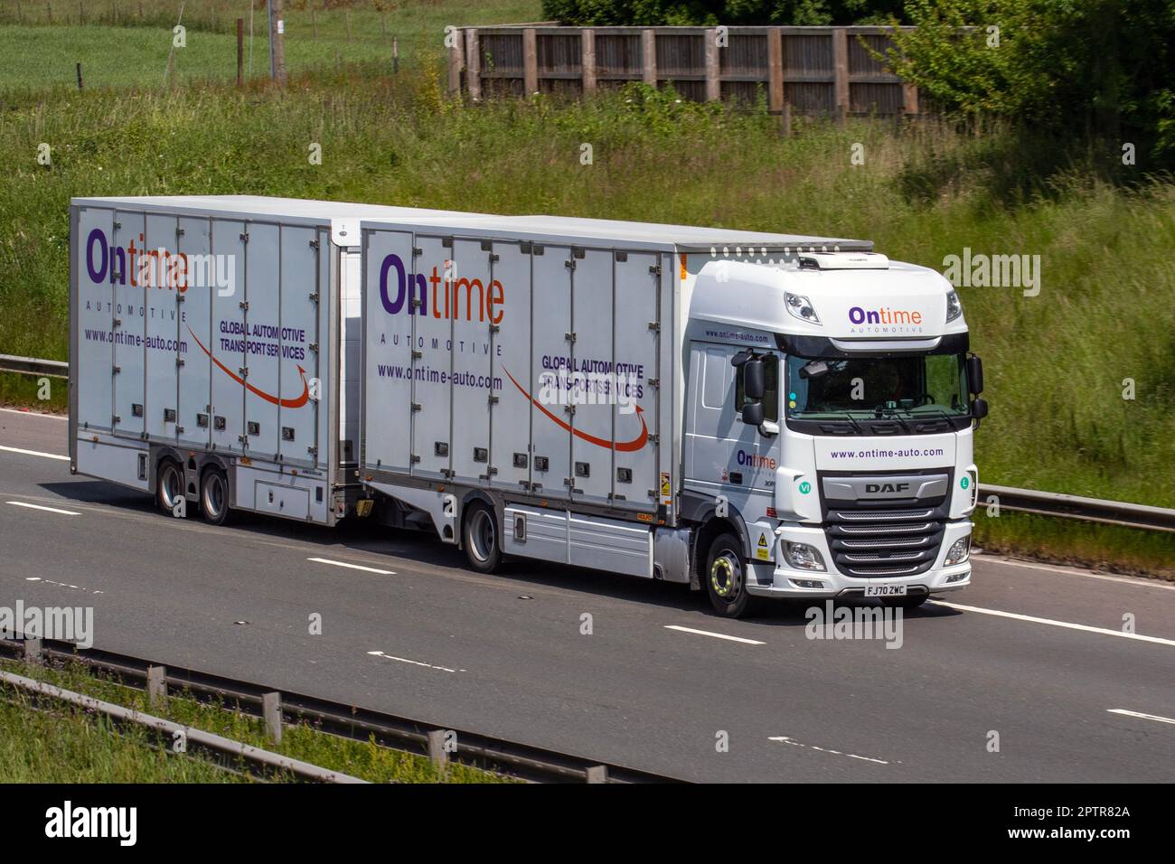 OnTime Automotive, specialist in vehicle transport services, enclosed car delivery operator DAF HGV with trailer; travelling on the M61 motorway, UK Stock Photo