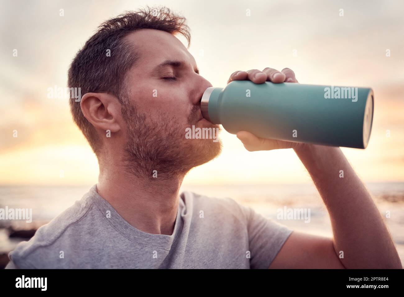 https://c8.alamy.com/comp/2PTR8E4/man-fitness-and-water-bottle-with-sunset-beach-background-for-thirst-hydration-and-healthy-lifestyle-while-outdoor-for-exercise-workout-and-trainin-2PTR8E4.jpg