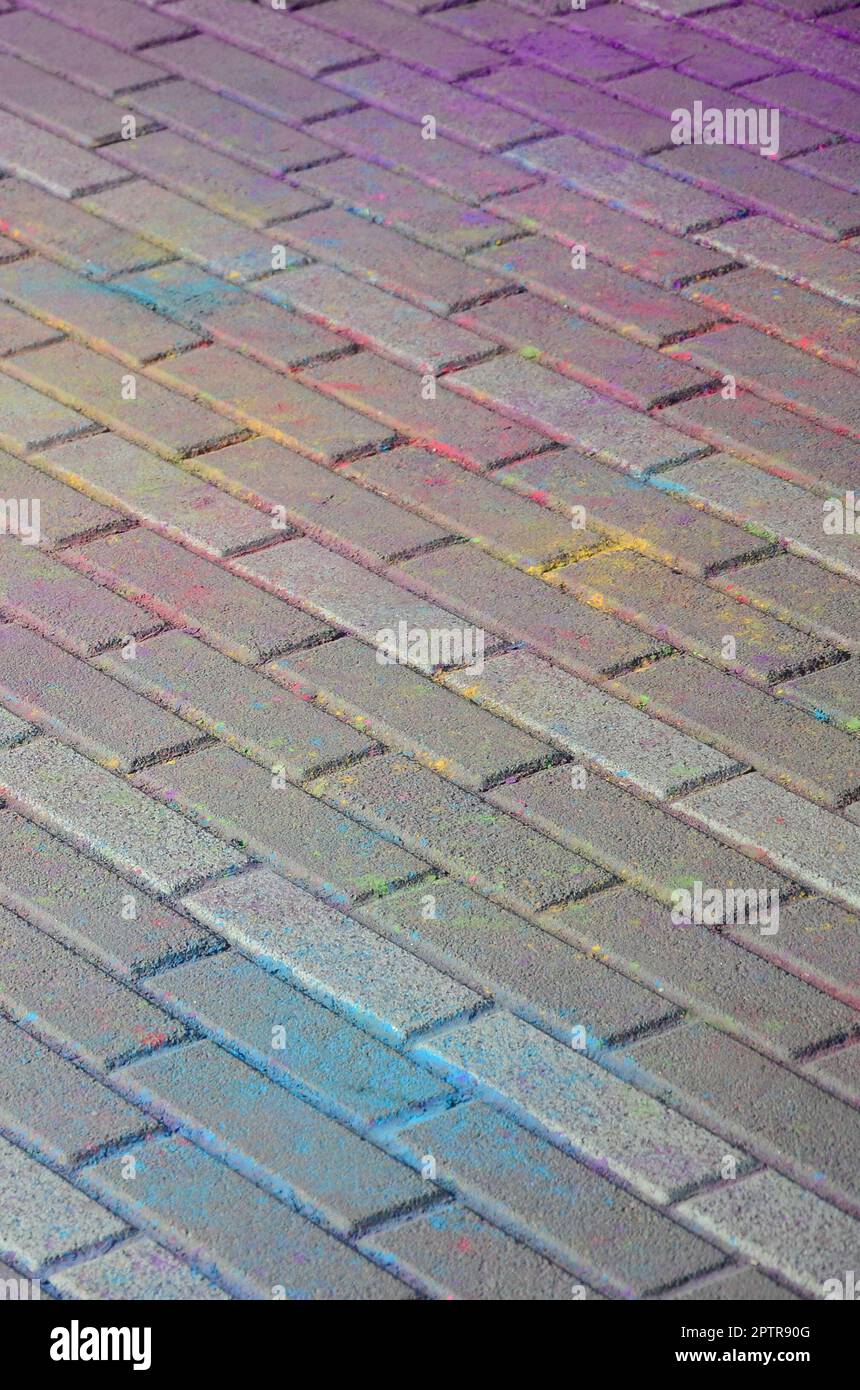 Multi colored earth, paving slabs, powder coated with dry colors at the