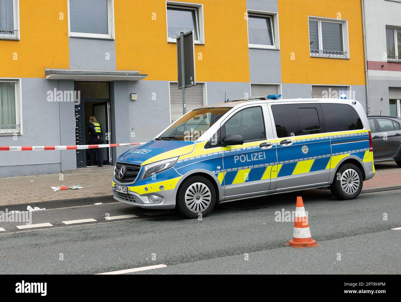 Duisburg, Germany. 28th Apr, 2023. A policewoman walks into a house in