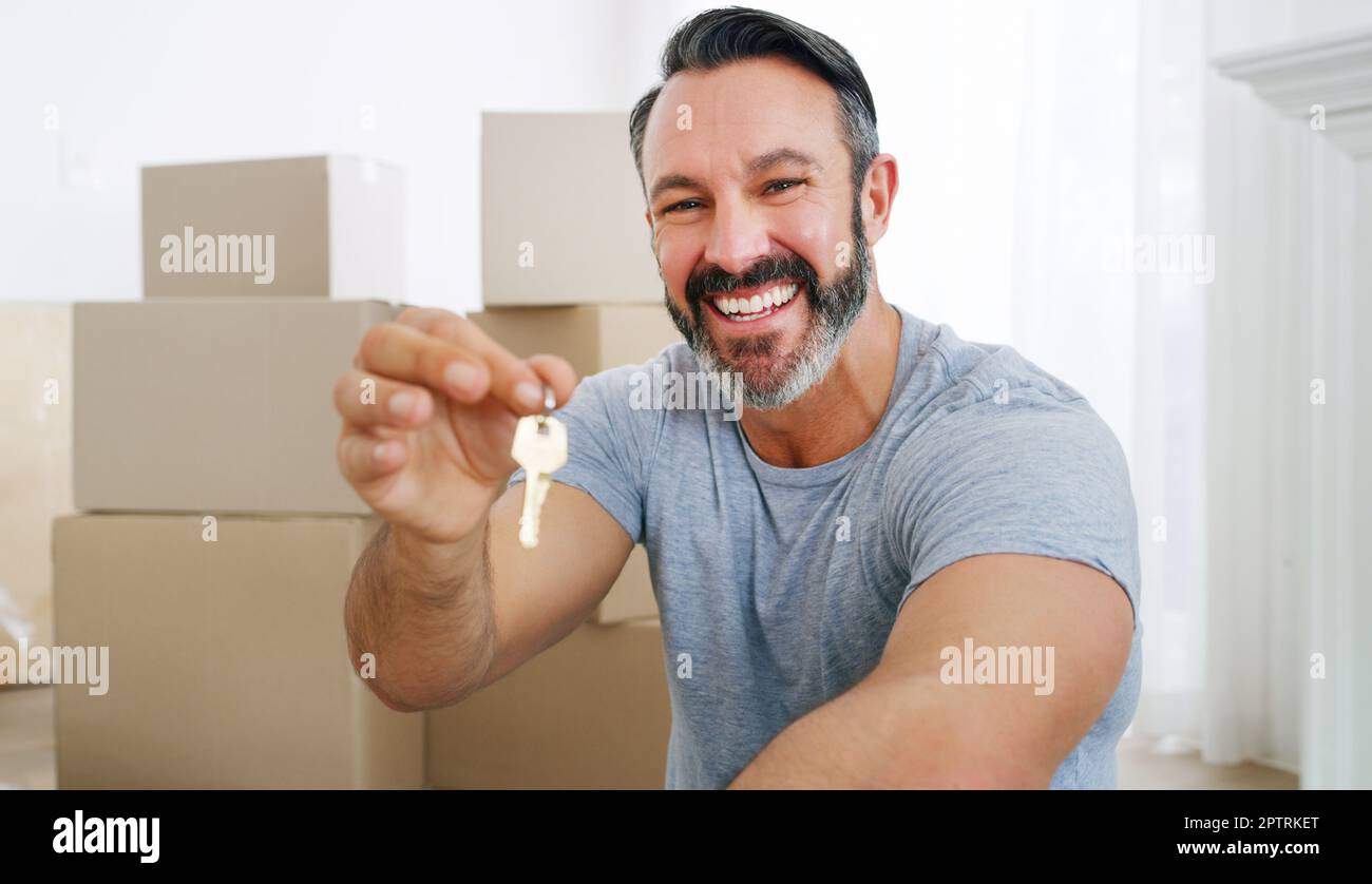 I made a great investment. a middle aged man holding the key to his new ...