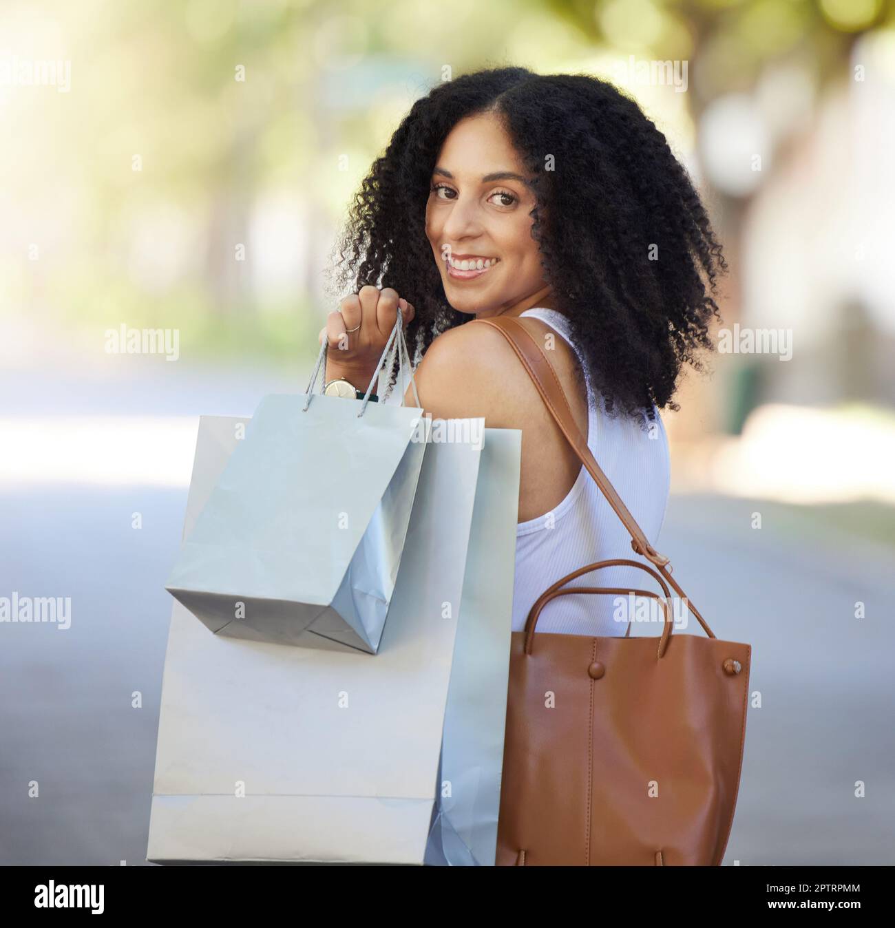 Portrait, fashion and black woman with shopping bag in city after buying clothing at mall. Black Friday deals, sales discount or happy female shopper Stock Photo