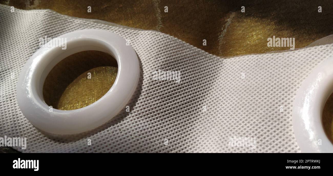 Plastic rings for attaching the fabric to the curtain rod. White