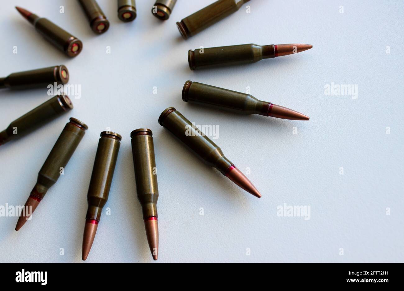Part of an even circle of unitary cartridges laid out on a white background Stock Photo