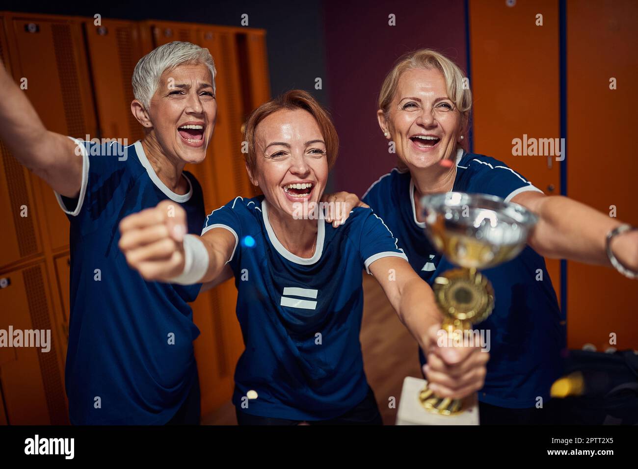 Senior women and young woman together celebrating first place in ...