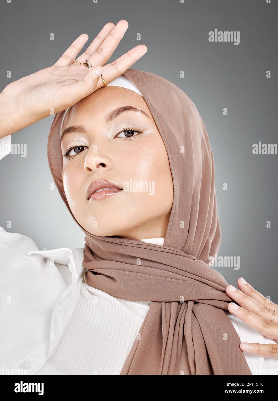 Modest female model wearing makeup with face covered in traditional hijab. Portrait of one beautiful young muslim woman wearing brown headscarf with h Stock Photo Alamy