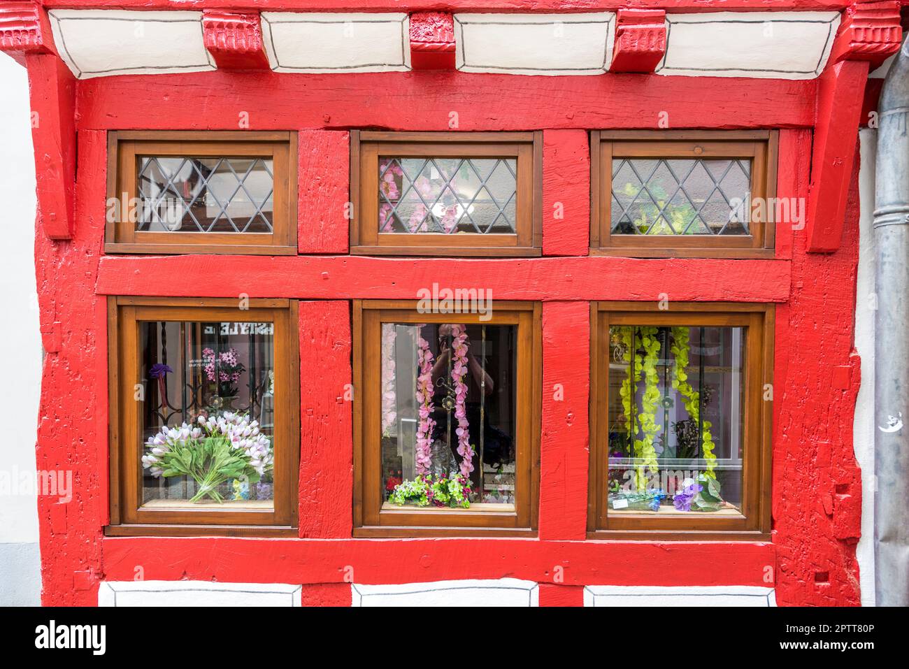 close up of red painted wooden window frames in a renovated half