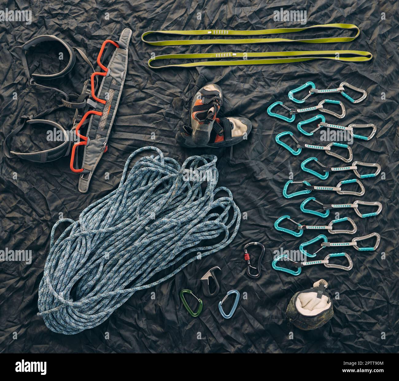 Closeup shot of a variety of carabiner hooks, rope, and other safety  equipment used for rock or mountain climbing against a dark background.  Needed fo Stock Photo - Alamy