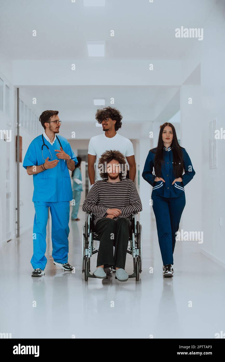 Two doctors and a nurse walking down a hospital hallway, pushing a ...