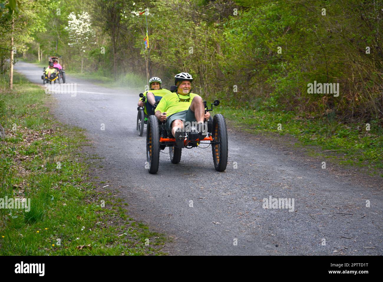 A man riding a recumbent trike bicycle rides along the Virginia Creeper