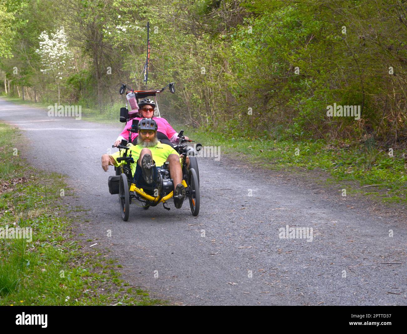 Couples riding recumbent trike bicycles ride along the Virginia Creeper
