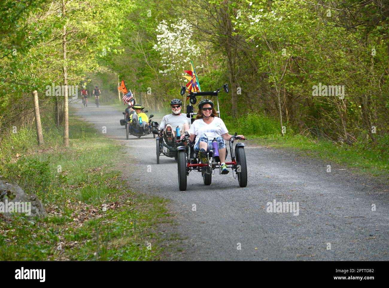 Couples riding recumbent trike bicycles ride along the Virginia Creeper ...