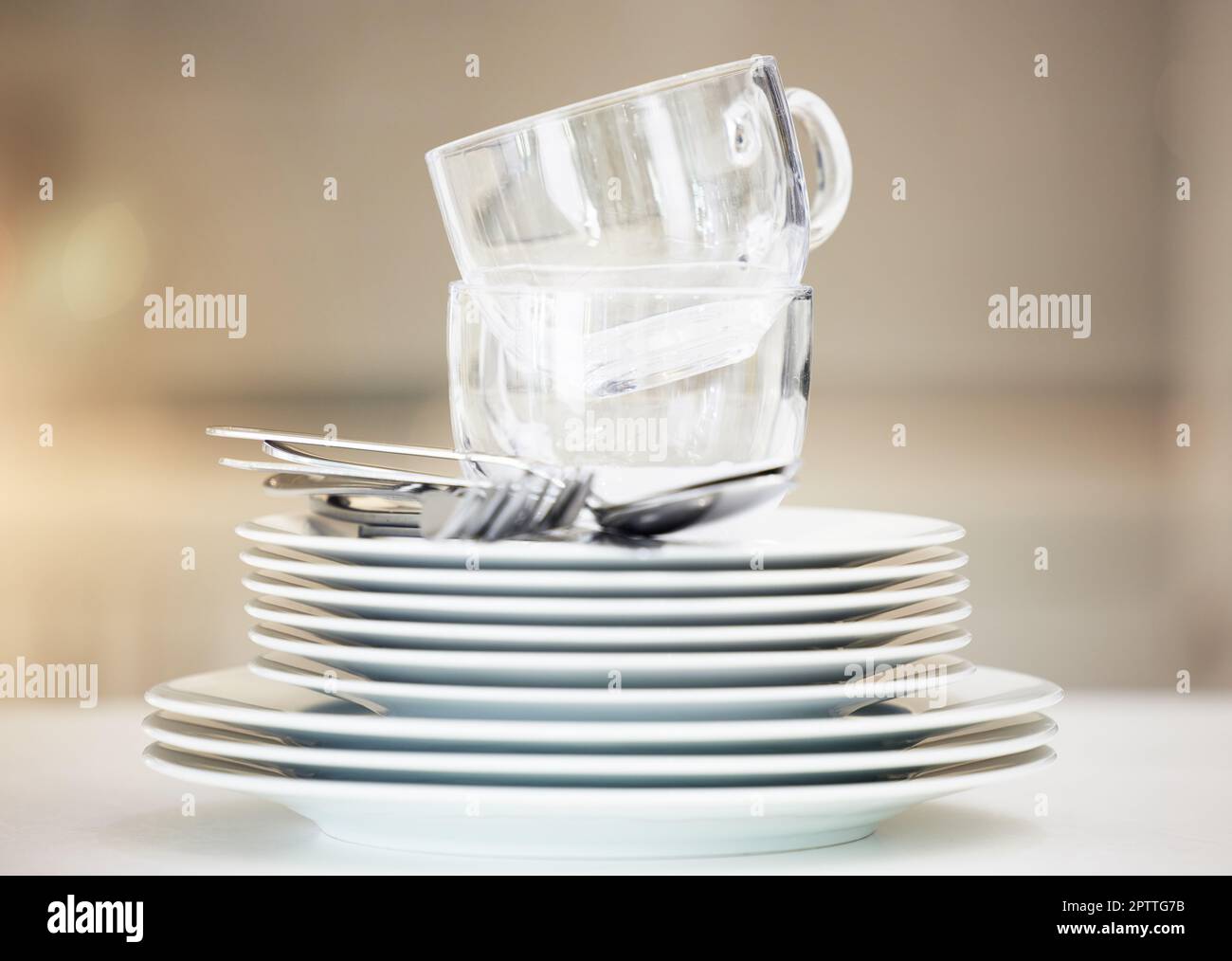 Closeup of a stack of clean dishes. Spotless pile of dishes straight