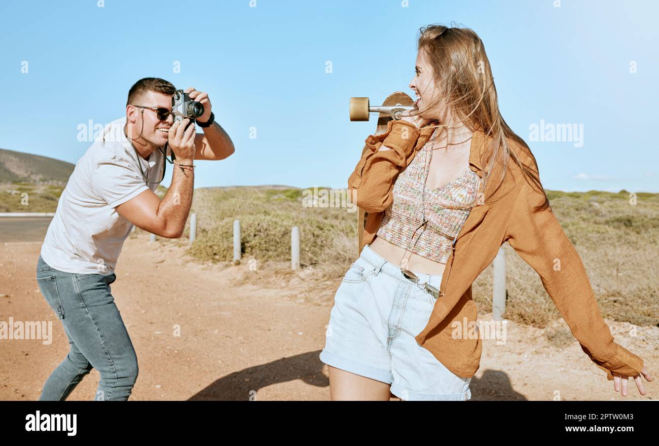 Photo, skateboard and couple on a road trip in nature travel during summer. Photographer, love and man with a vintage camera and picture of an infl Stock Photo - Alamy