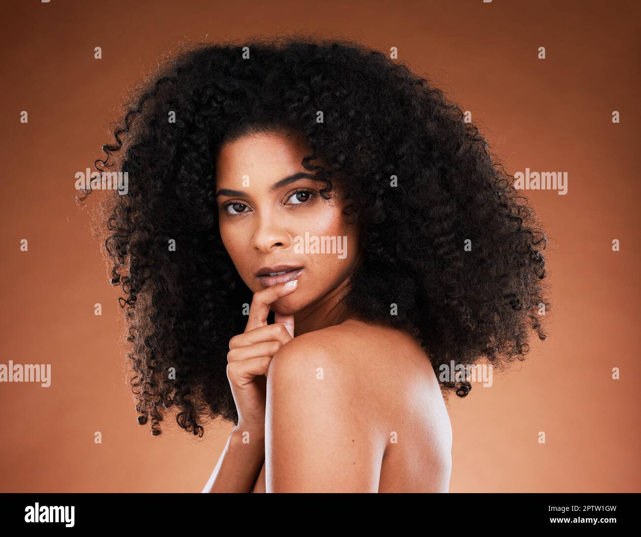Beauty, makeup and portrait of a black woman with an afro against a