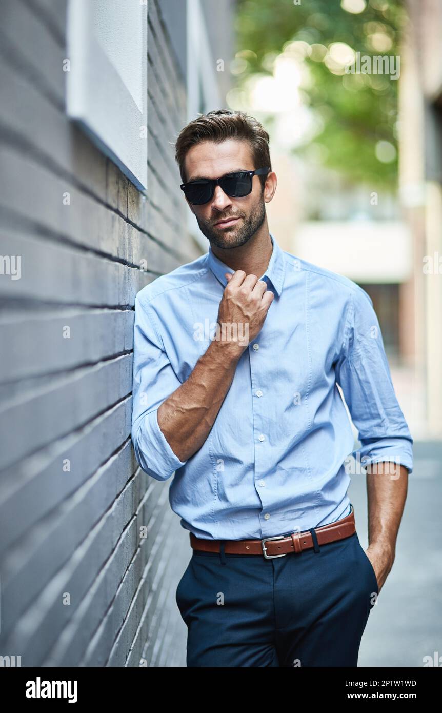Business fashion confidence and portrait of man with glasses professional clothes and leaning on city wall. Designer outfit luxury apparel and busi Stock Photo Alamy