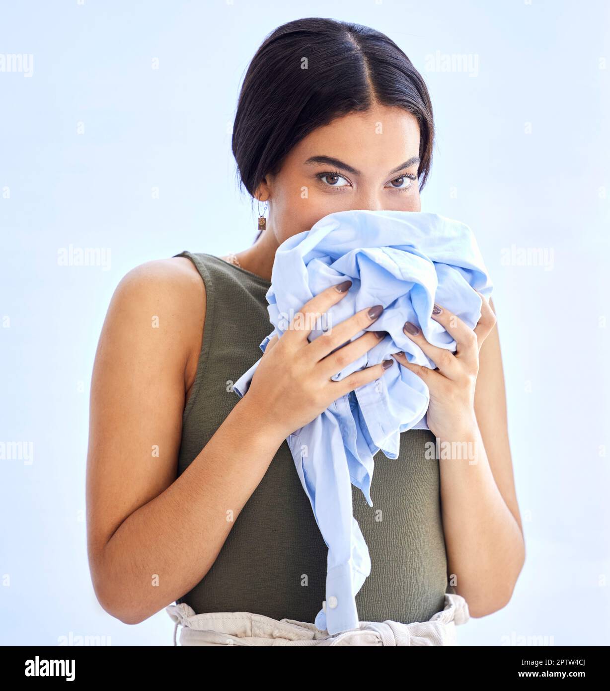 Fresh, laundry and woman smelling clean clothes with a smile, peace and  calm in mockup studio background. Scent, clean and female smell clothing  aroma Stock Photo - Alamy