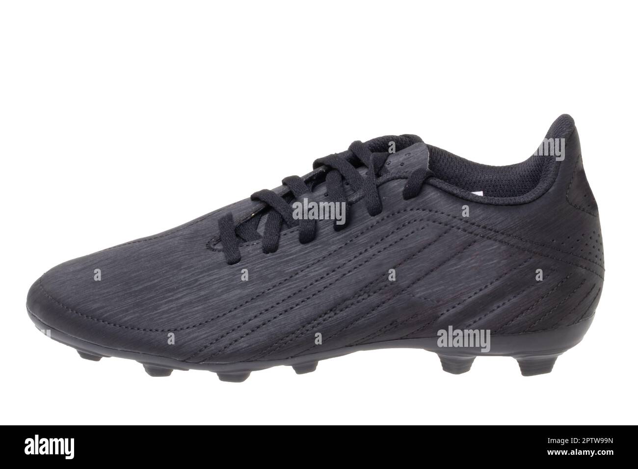 Closeup of a single black leather football boot isolated on white background. Professional
