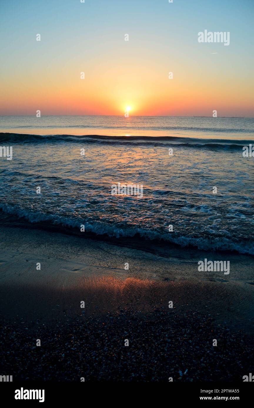 Beautiful summer landscape, sunset at the beach, sparkly sand and waves ...
