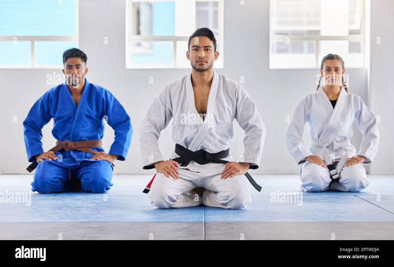 Portrait, training and karate group with coach in dojo ready for