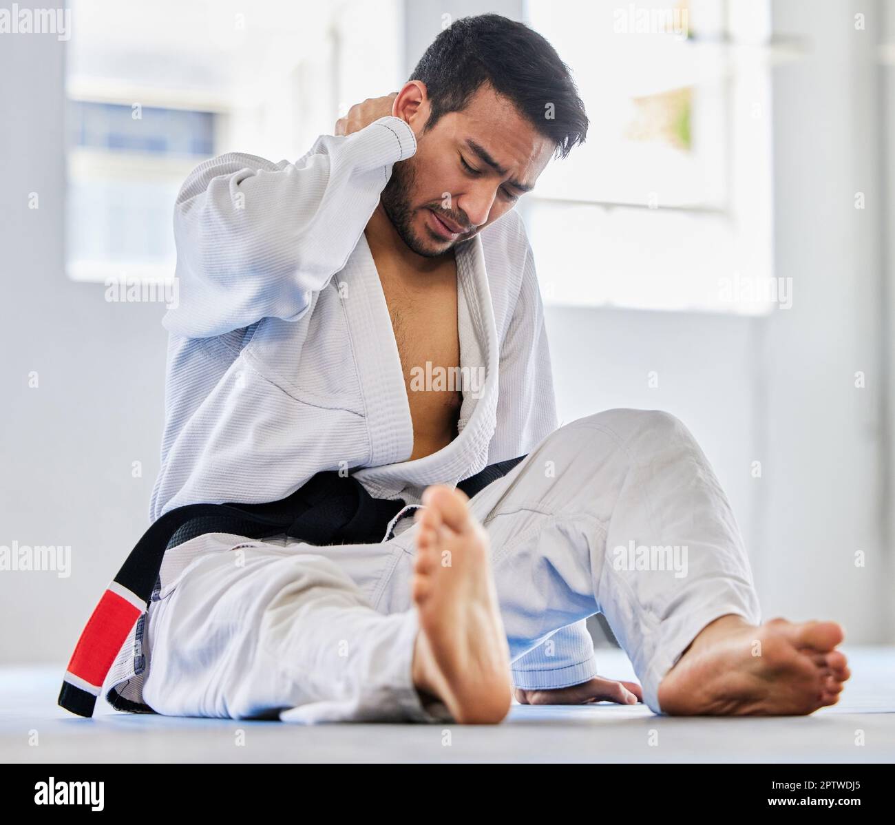 Karate, sports injury and neck pain of man at fitness club for martial arts, exercise and